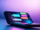 Futuristic smartphone displaying an engaging AI chat conversation with colorful speech bubbles and digital effects.