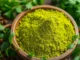 Fresh coriander powder in a bowl with coriander leaves and spices for authentic flavor enhancement